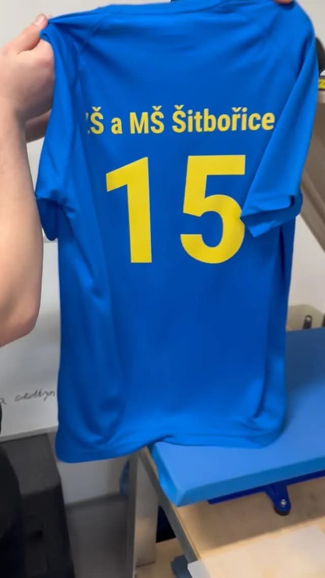 Modré tričko s nápisem ZŠ a MŠ Šitbořice a číslem 15 na zádech